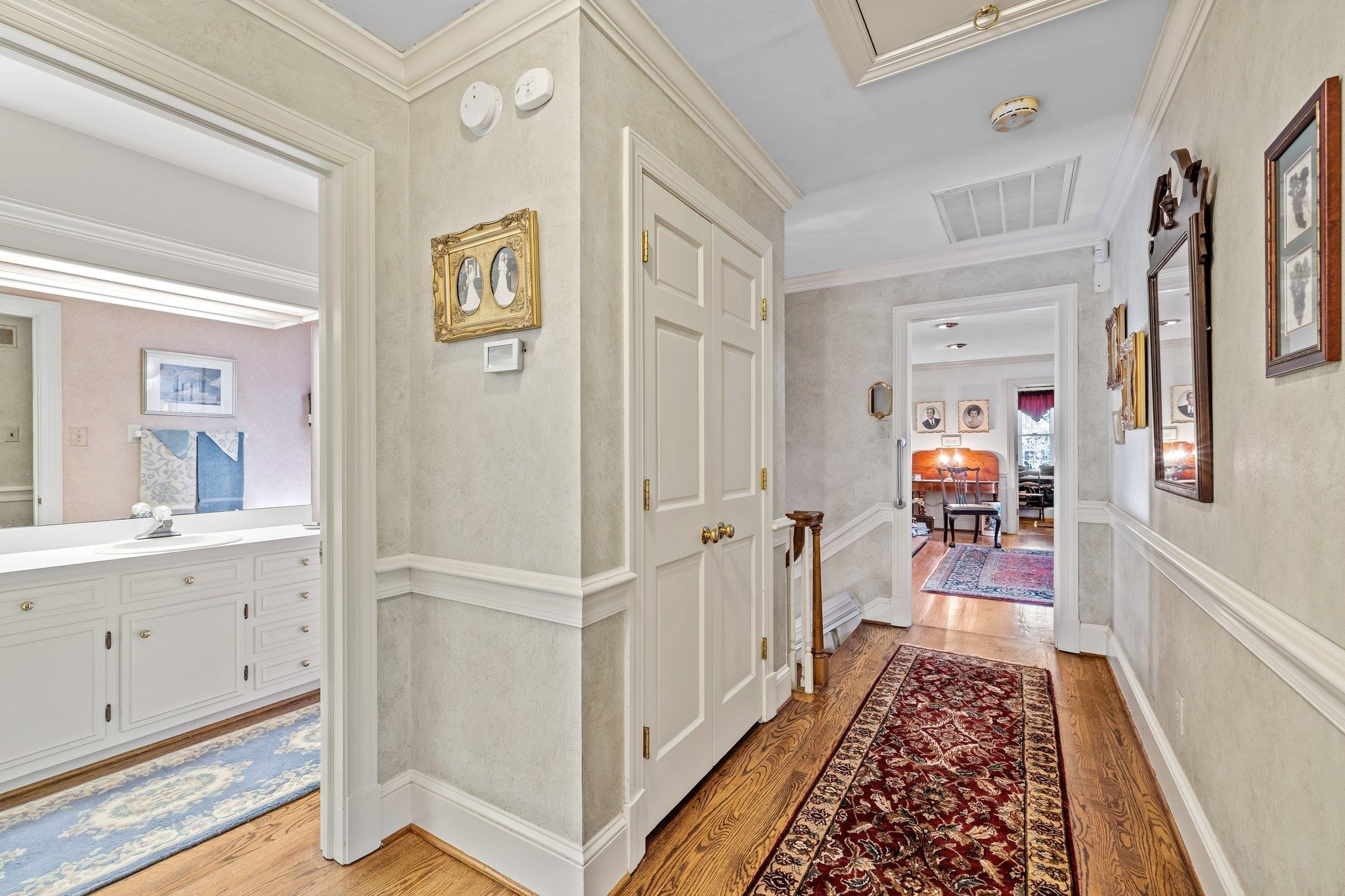 3608 Dover Road Durham, NC 27707 - Photo 49 of 60 a hallway with white cabinets and wooden floor