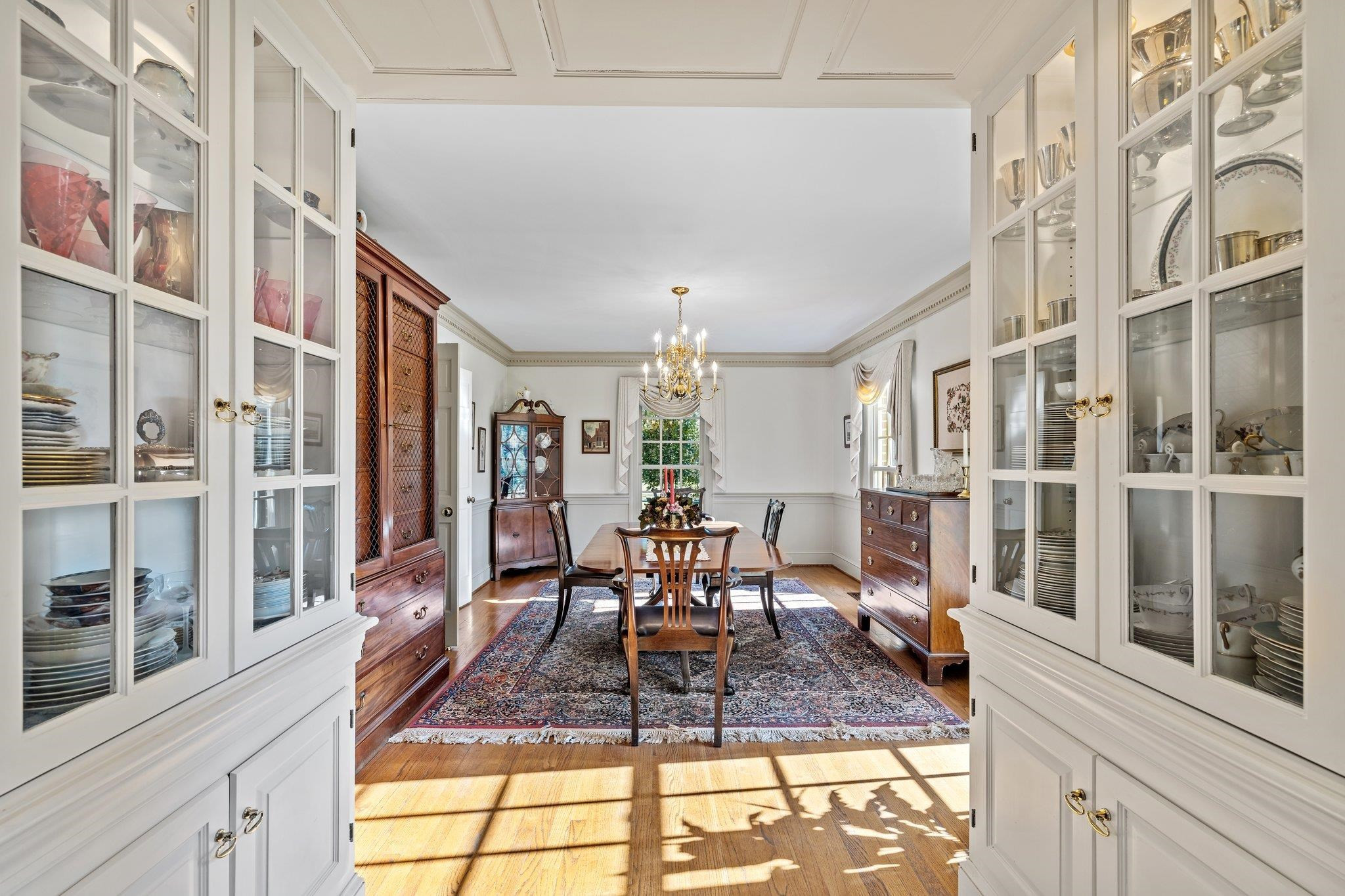 3608 Dover Road Durham, NC 27707 - Photo 6 of 60 a view of a dining room with furniture a chandelier and wooden floor