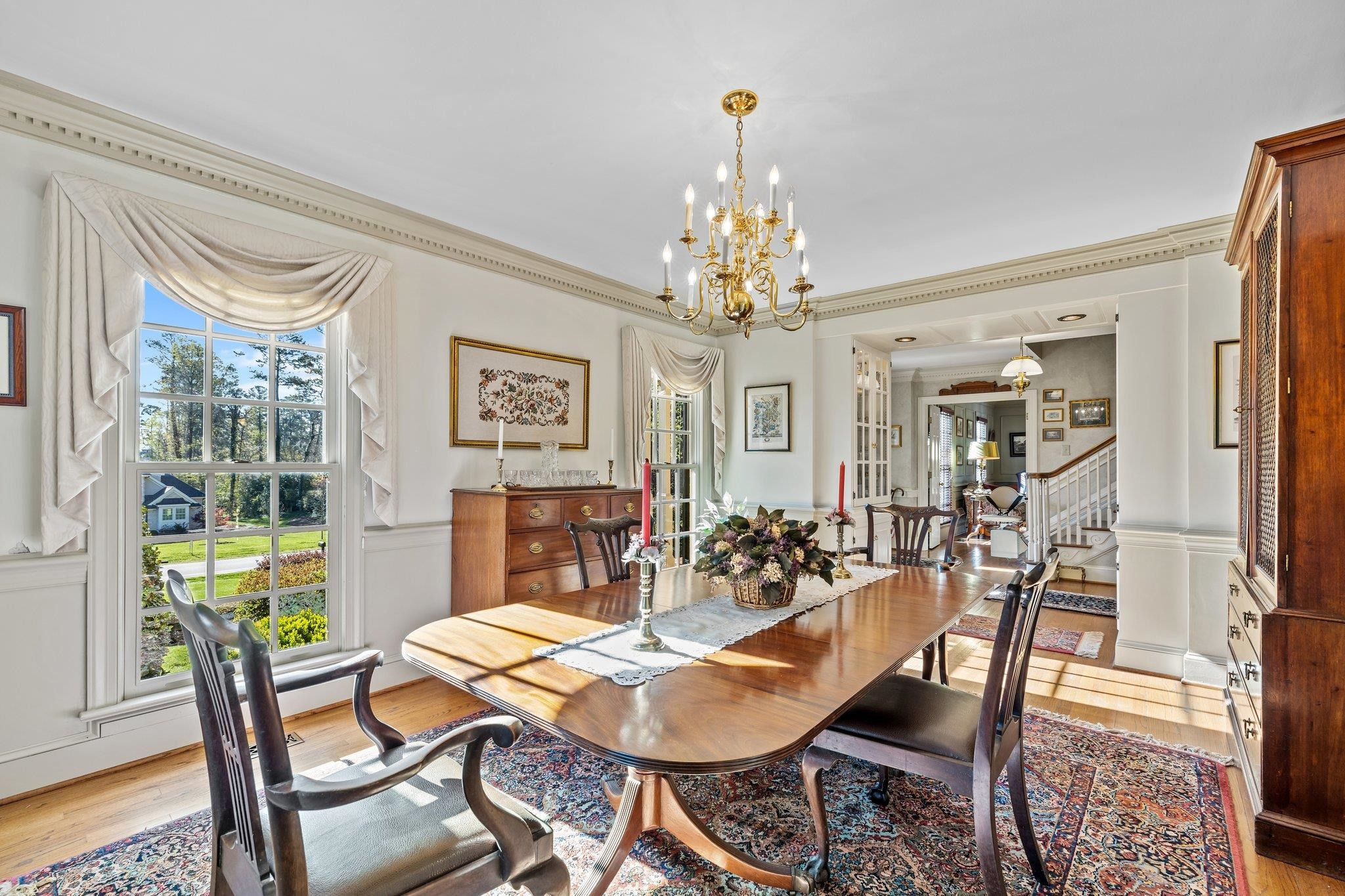 3608 Dover Road Durham, NC 27707 - Photo 7 of 60 a view of a dining room with furniture a chandelier and wooden floor
