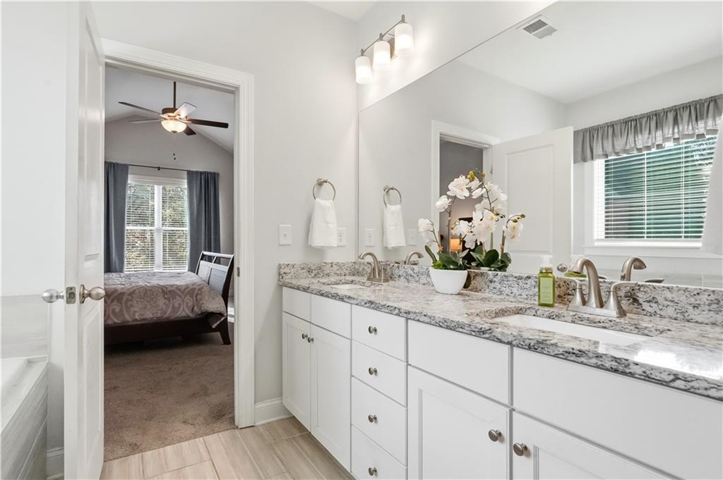 8745 Hightower Ridge Ball Ground, GA 30107 - Photo 14 of 36 a en suite bathroom with double sink and a mirror