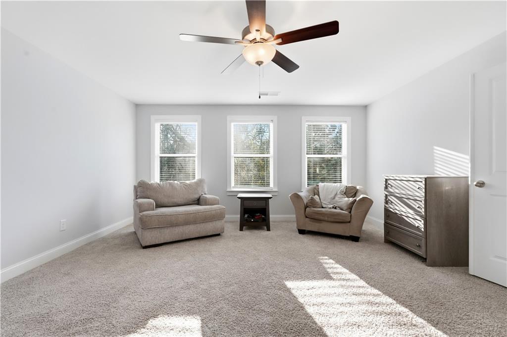 8745 Hightower Ridge Ball Ground, GA 30107 - Photo 16 of 36 a living room with furniture and a large window