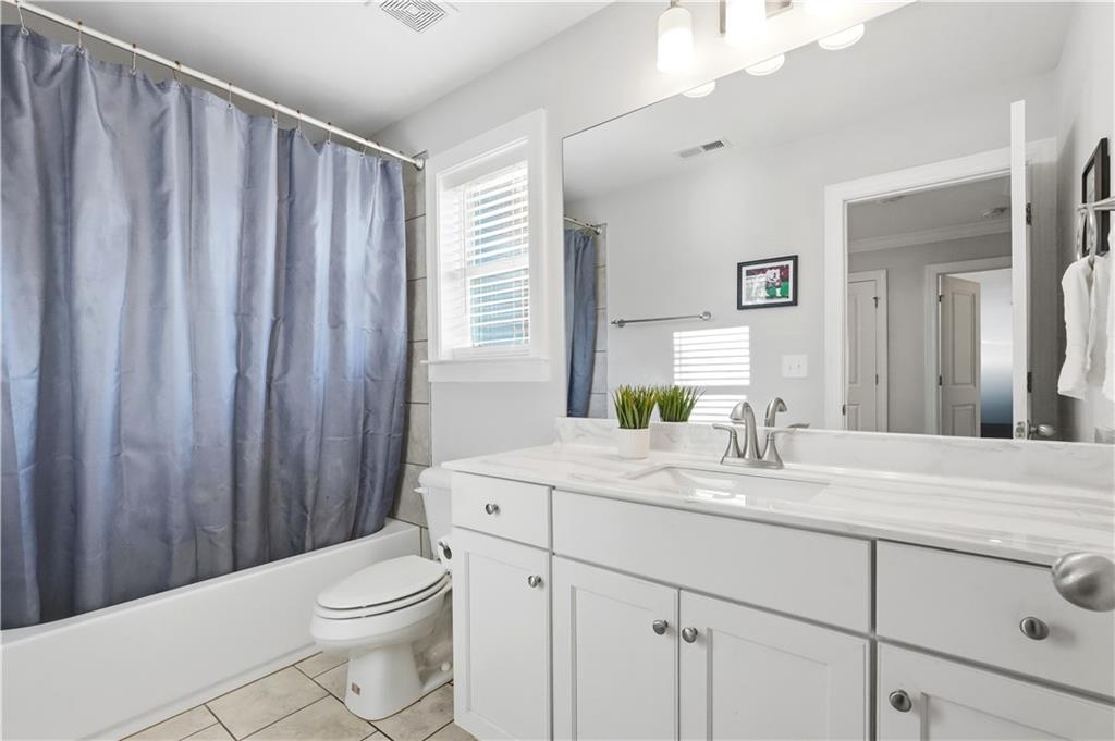 8745 Hightower Ridge Ball Ground, GA 30107 - Photo 21 of 36 a bathroom with a granite countertop sink toilet and mirror