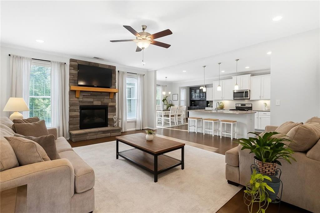 8745 Hightower Ridge Ball Ground, GA 30107 - Photo 3 of 36 a living room with furniture and a fireplace