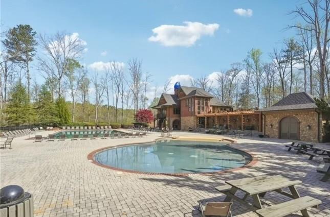 8745 Hightower Ridge Ball Ground, GA 30107 - Photo 31 of 36 a view of a swimming pool with a patio