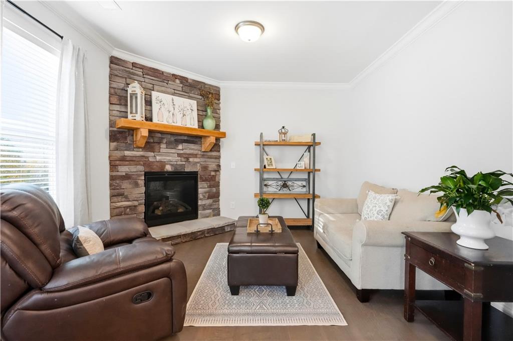 8745 Hightower Ridge Ball Ground, GA 30107 - Photo 5 of 36 a living room with furniture and a fireplace