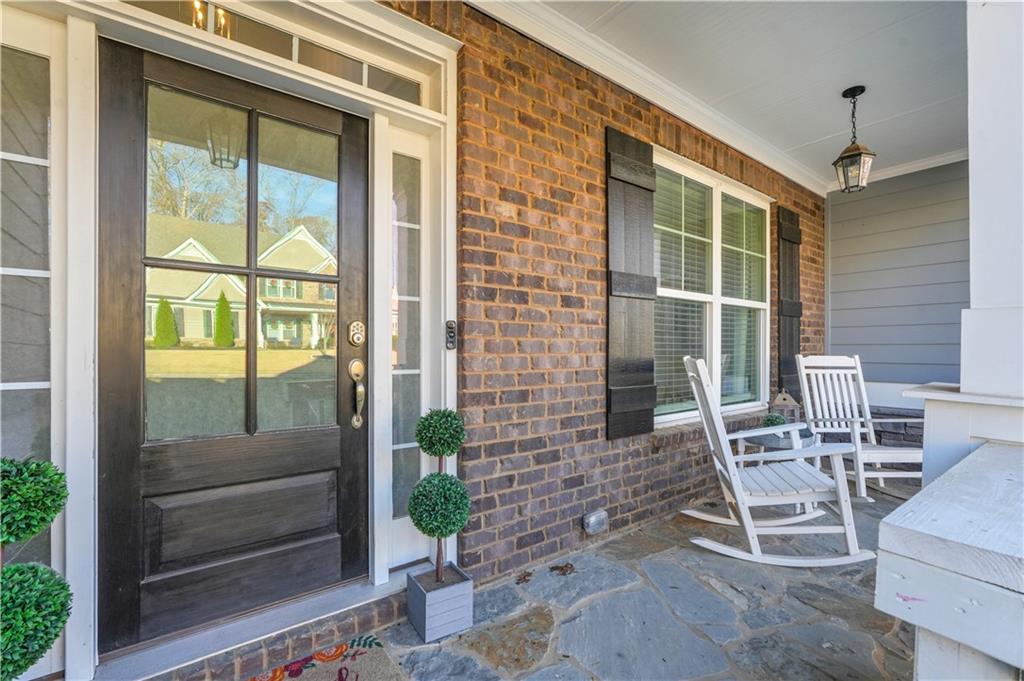 8745 Hightower Ridge Ball Ground, GA 30107 - Photo 6 of 36 a dining room with a glass top table and chairs