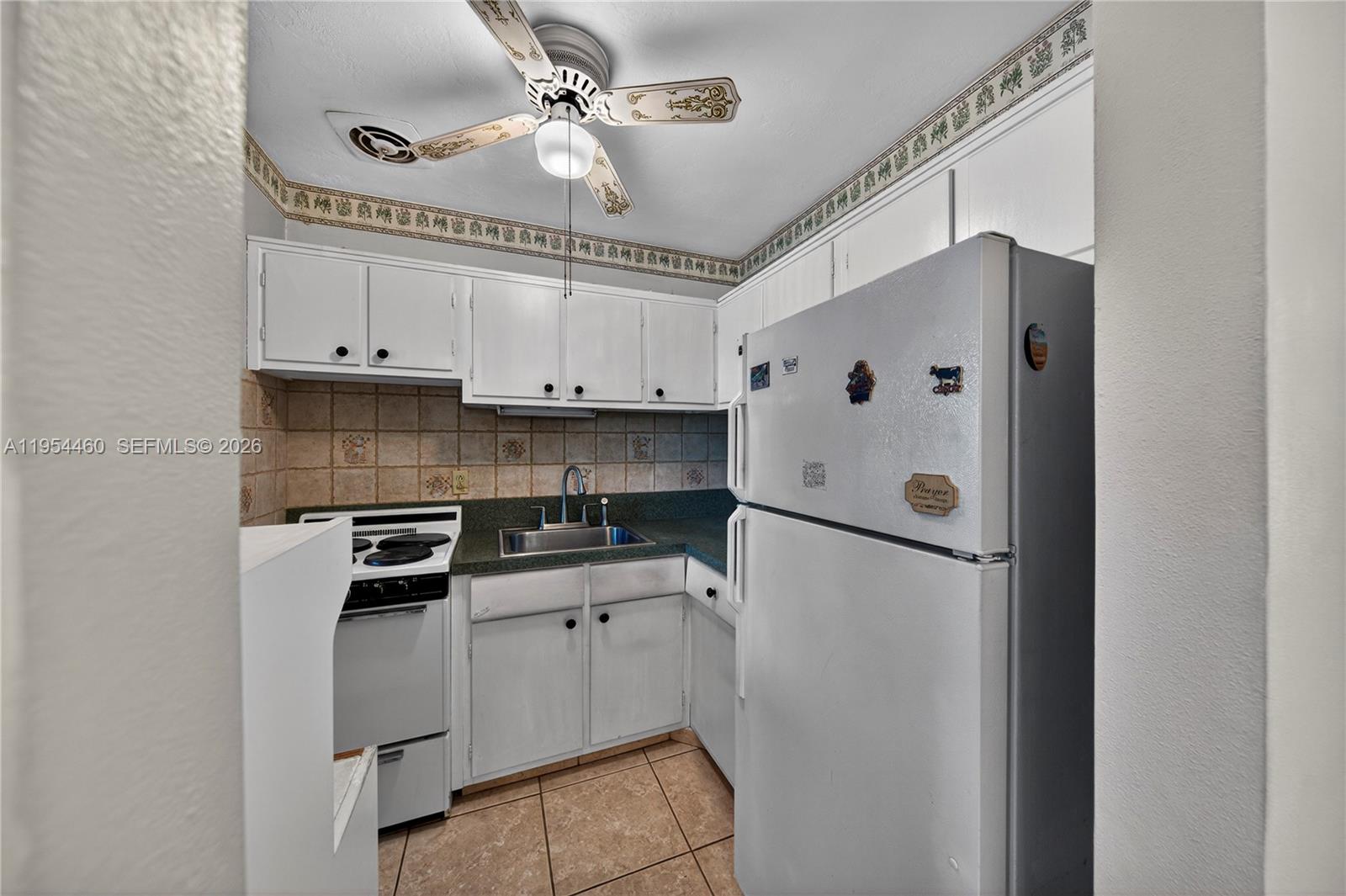 331 East McNab Road, Unit 226 Pompano Beach, FL 33060 - Photo 14 of 29 a white refrigerator freezer sitting inside of a kitchen