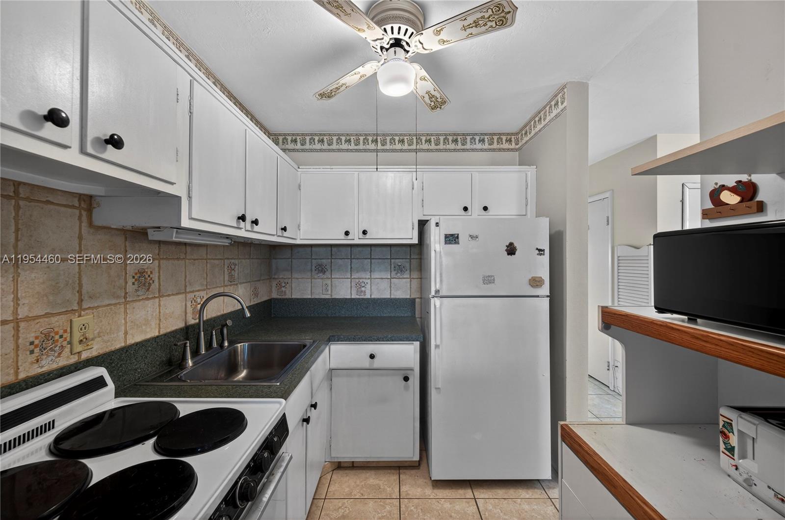 331 East McNab Road, Unit 226 Pompano Beach, FL 33060 - Photo 15 of 29 a kitchen with stainless steel appliances a sink a stove a refrigerator and cabinets