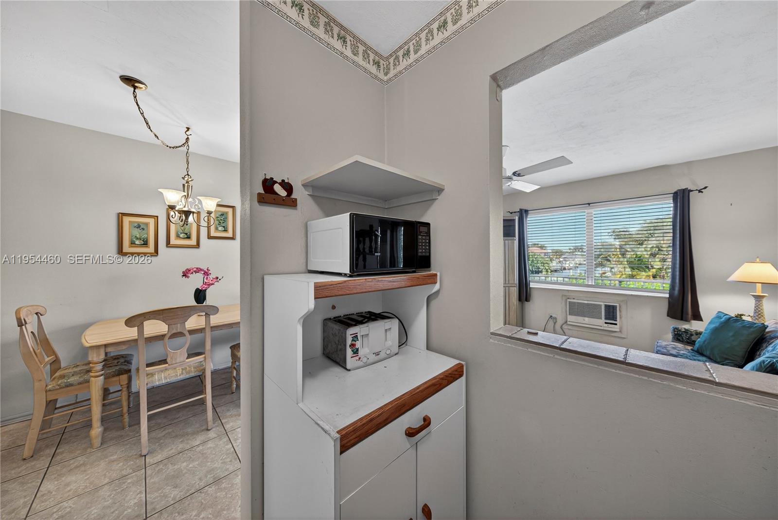 331 East McNab Road, Unit 226 Pompano Beach, FL 33060 - Photo 16 of 29 a living room with furniture a flat screen tv and a refrigerator