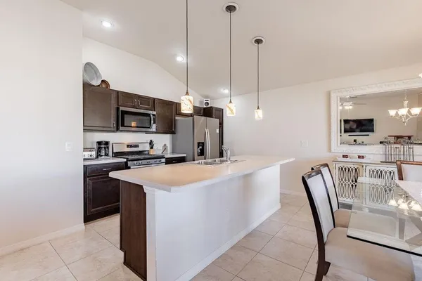 a kitchen with stainless steel appliances a stove a microwave and a sink