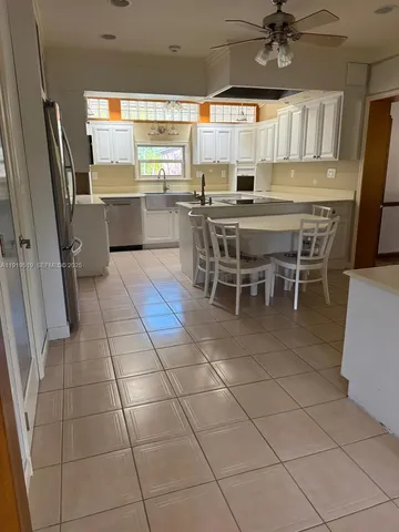 a kitchen with stainless steel appliances a sink and cabinets