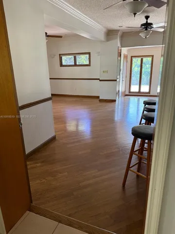 a view of a livingroom with furniture and hardwood floor
