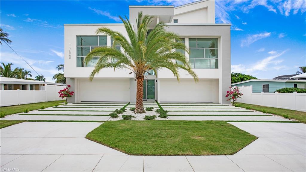 Modern home with driveway, stucco siding, and a garage
