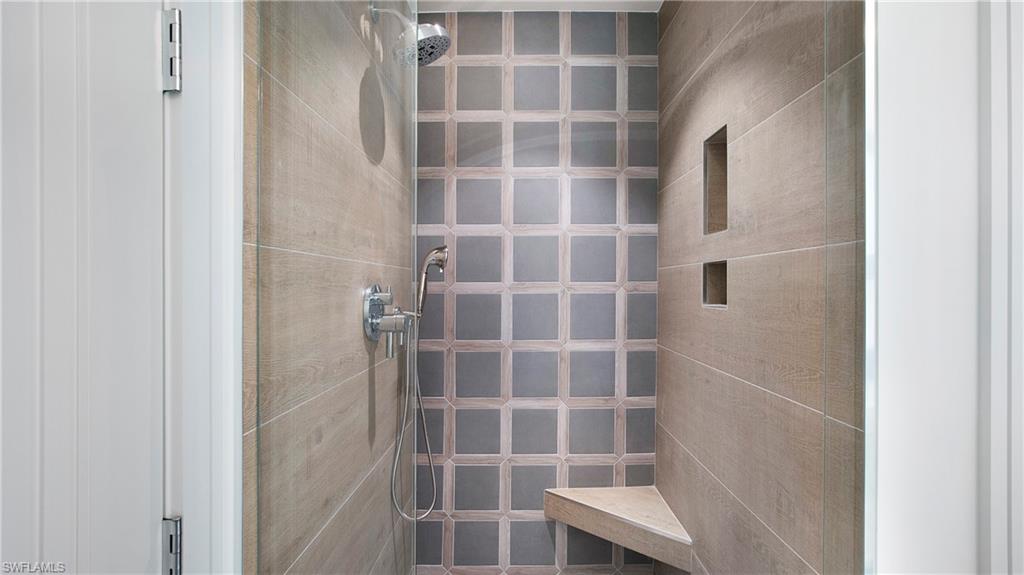1798 Holiday Lane Naples, FL 34104 - Photo 21 of 47 Bathroom featuring a tile shower