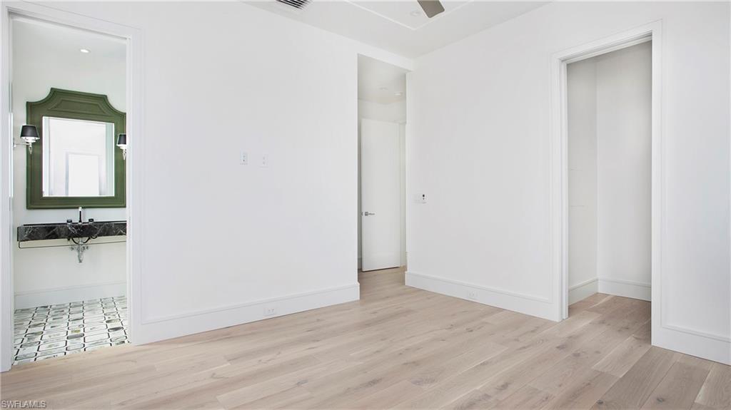 1798 Holiday Lane Naples, FL 34104 - Photo 22 of 47 Unfurnished bedroom with wood finished floors and a ceiling fan