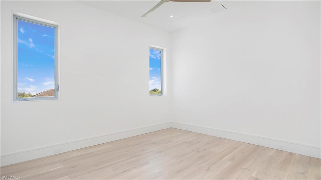 1798 Holiday Lane Naples, FL 34104 - Photo 25 of 47 Unfurnished room with light wood-type flooring and ceiling fan