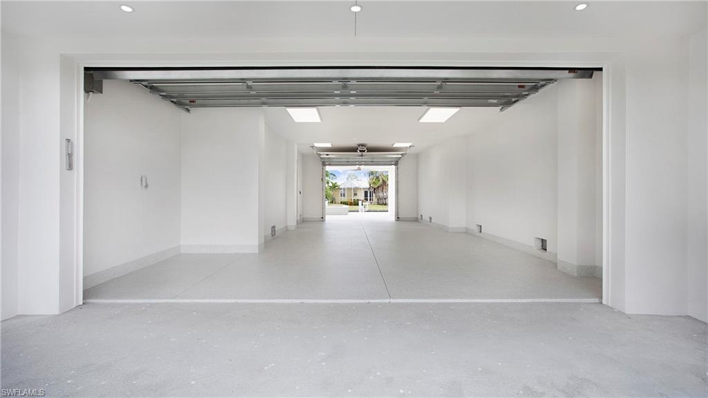 1798 Holiday Lane Naples, FL 34104 - Photo 31 of 47 Garage with recessed lighting and baseboards