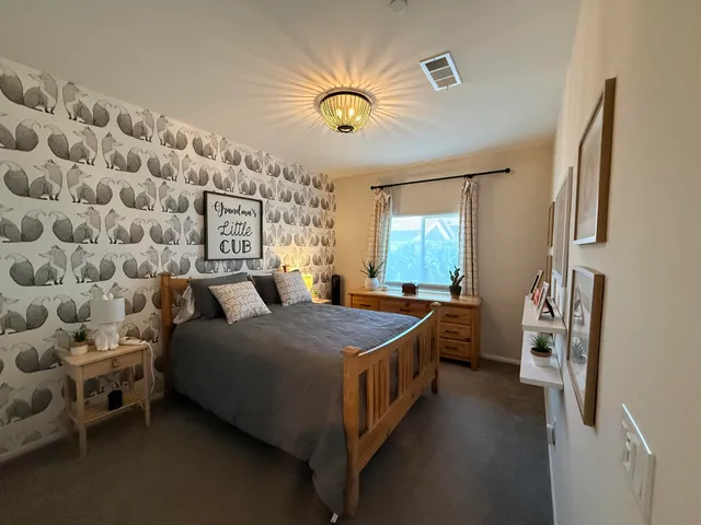 a spacious bedroom with a bed and a window