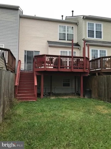 a view of a house with wooden fence