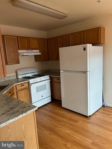 a white refrigerator freezer sitting in a kitchen