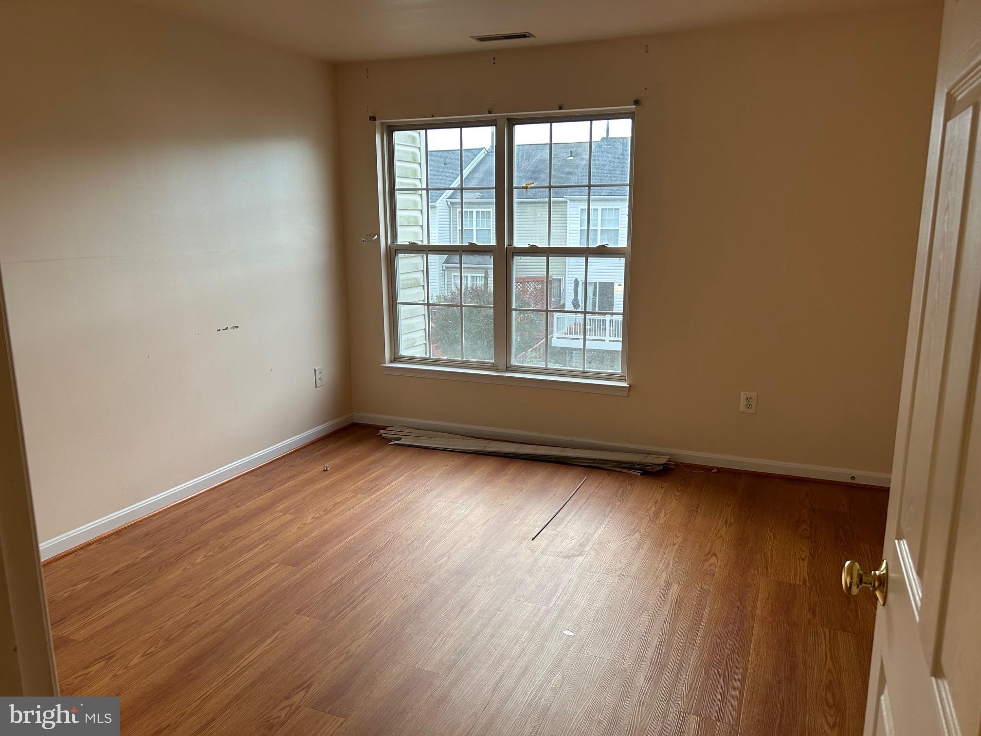 206 Arcadia Shores Circle Odenton, MD 21113 - Photo 8 of 15 an empty room with wooden floor and windows
