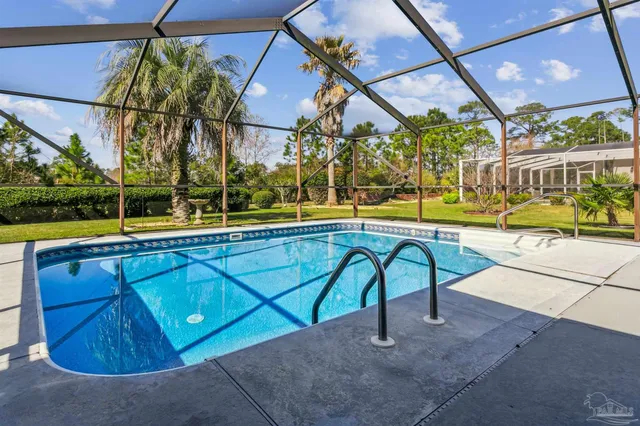 a view of swimming pool with a patio and a yard