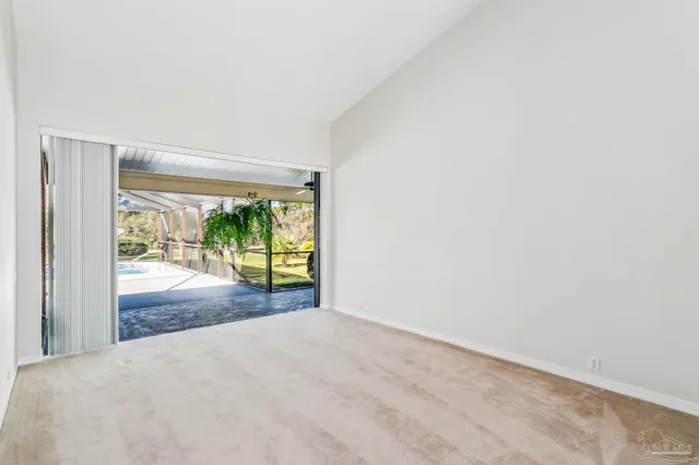 a view of a big room with wooden floor and front door