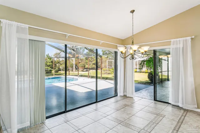 a view of a room with window and chandelier