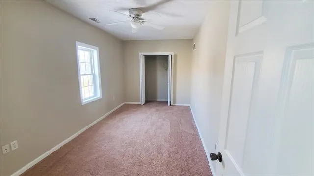 an empty room with windows and entrance