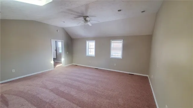 a bathroom with a toilet and a mirror