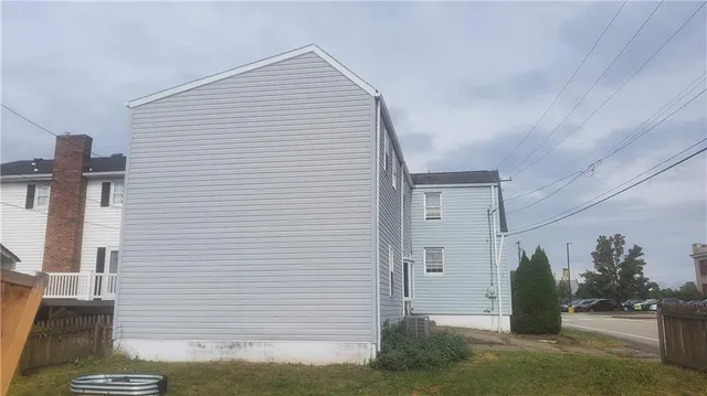 a view of a house with a backyard and porch