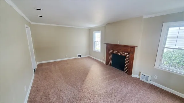 a view of empty room with a fireplace