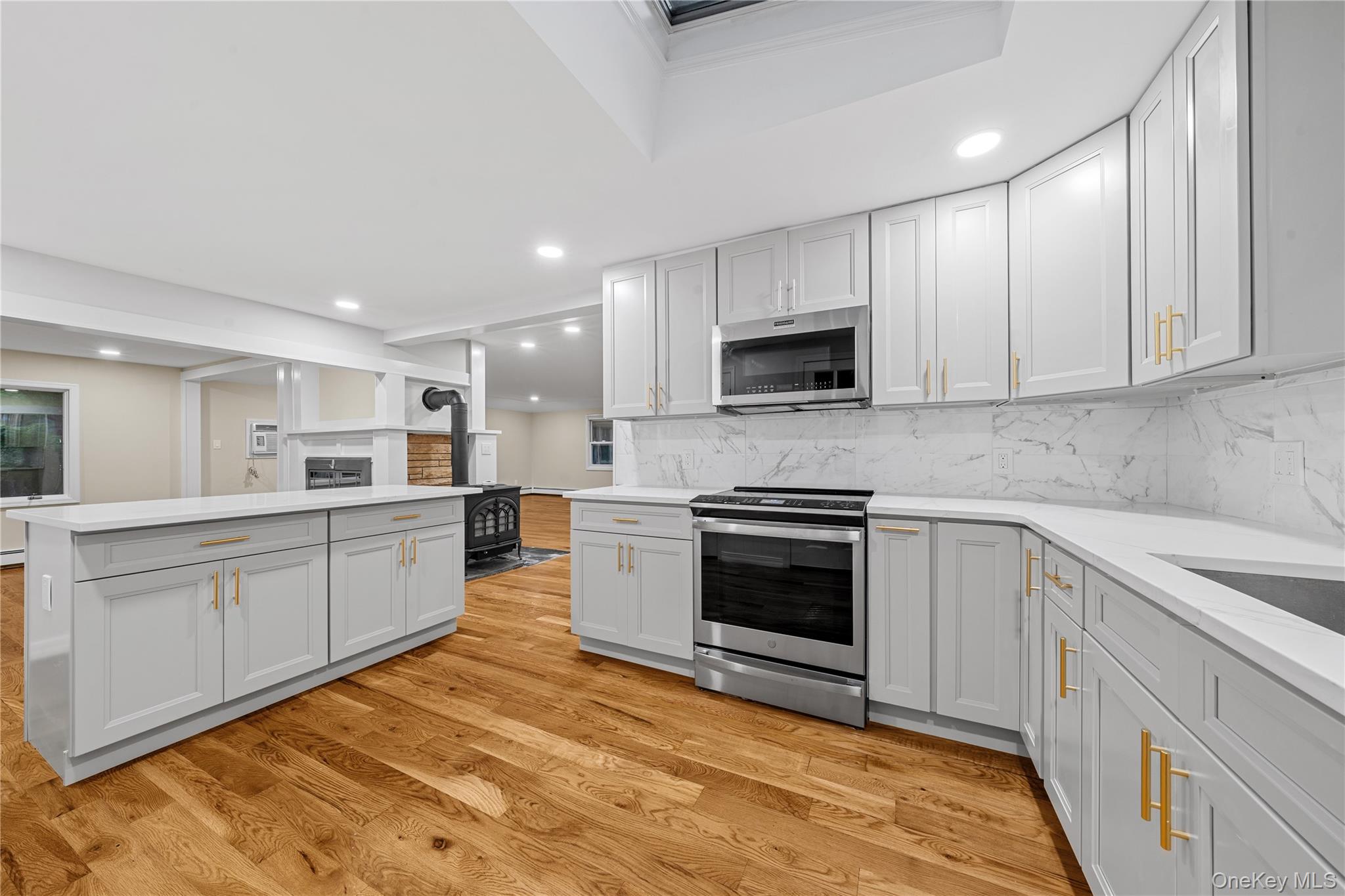 57 Eastwood Road Miller Place, NY 11764 - Photo 15 of 49 a large kitchen with cabinets