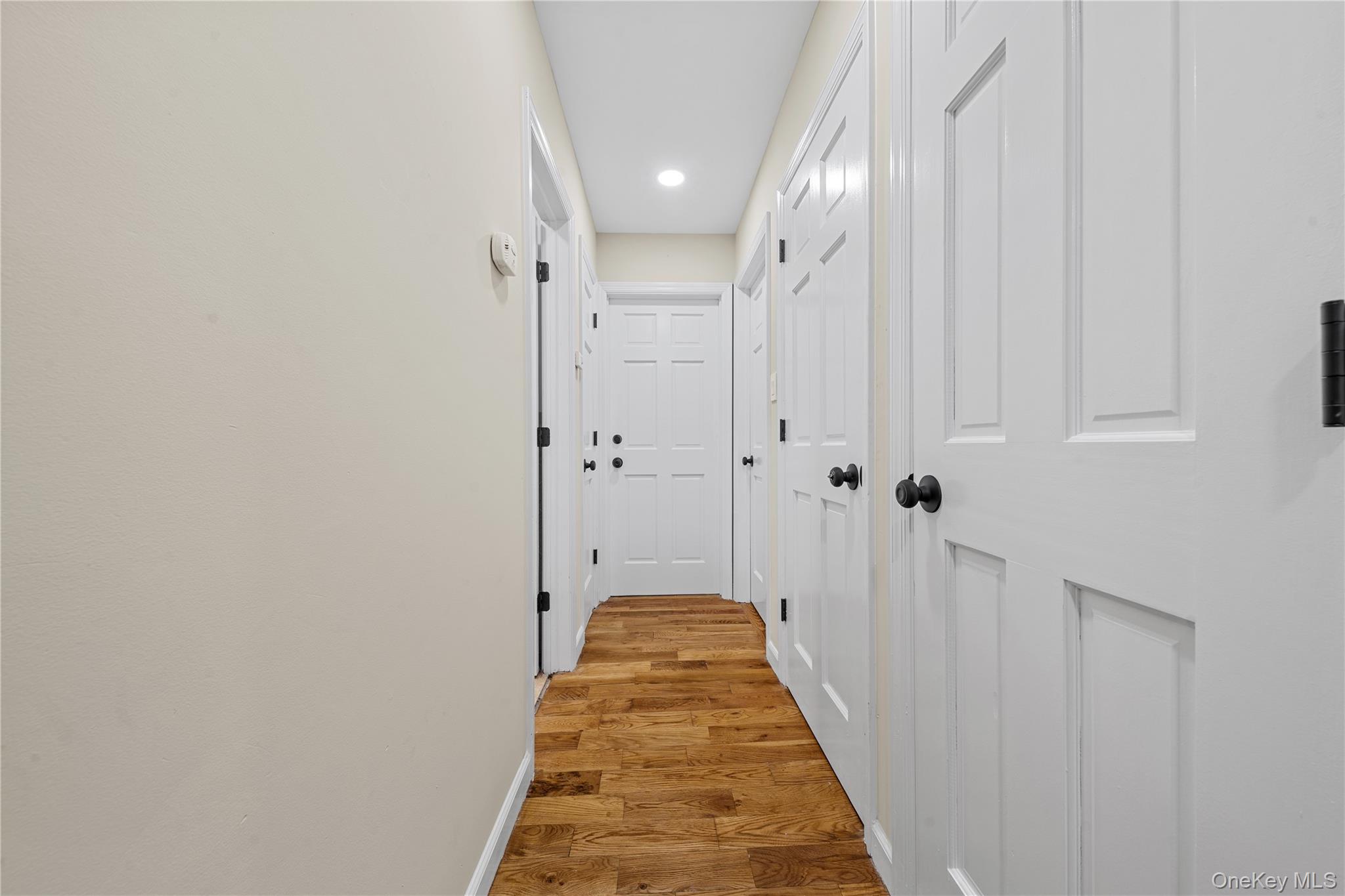 57 Eastwood Road Miller Place, NY 11764 - Photo 17 of 49 a view of a hallway with a white door