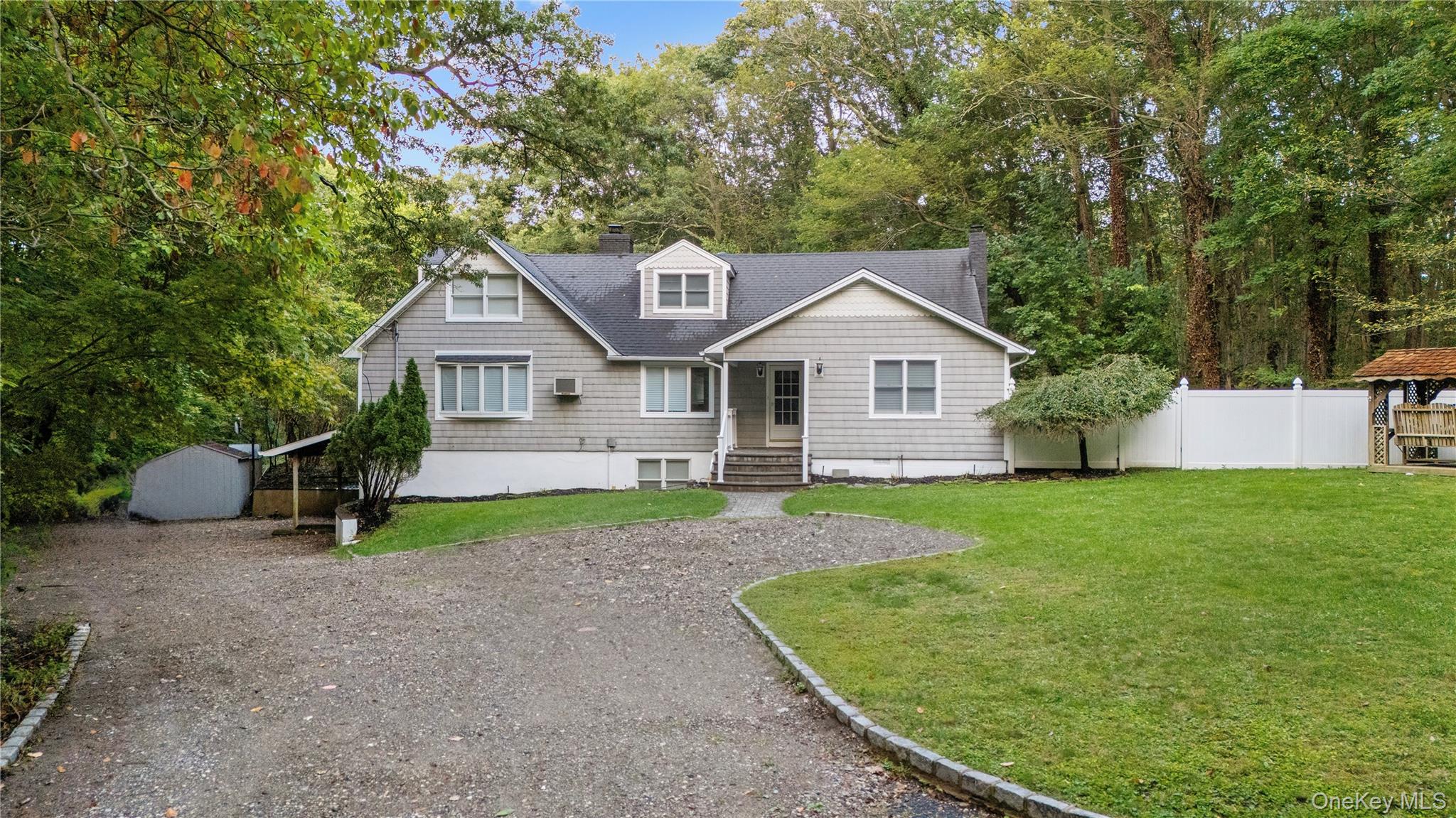57 Eastwood Road Miller Place, NY 11764 - Photo 2 of 49 a view of a house with a yard and sitting area