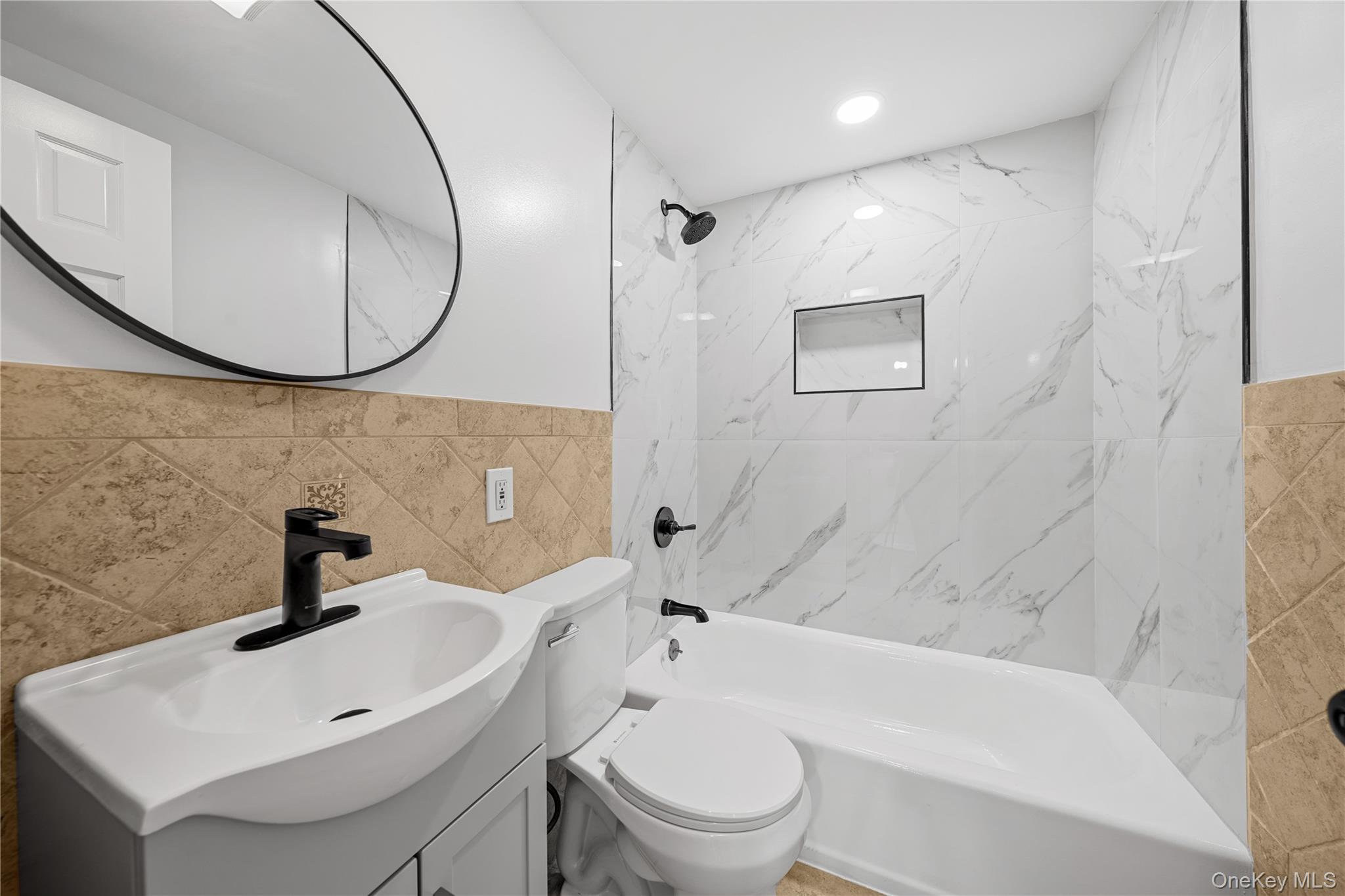 57 Eastwood Road Miller Place, NY 11764 - Photo 23 of 49 a bathroom with a sink a toilet and a mirror