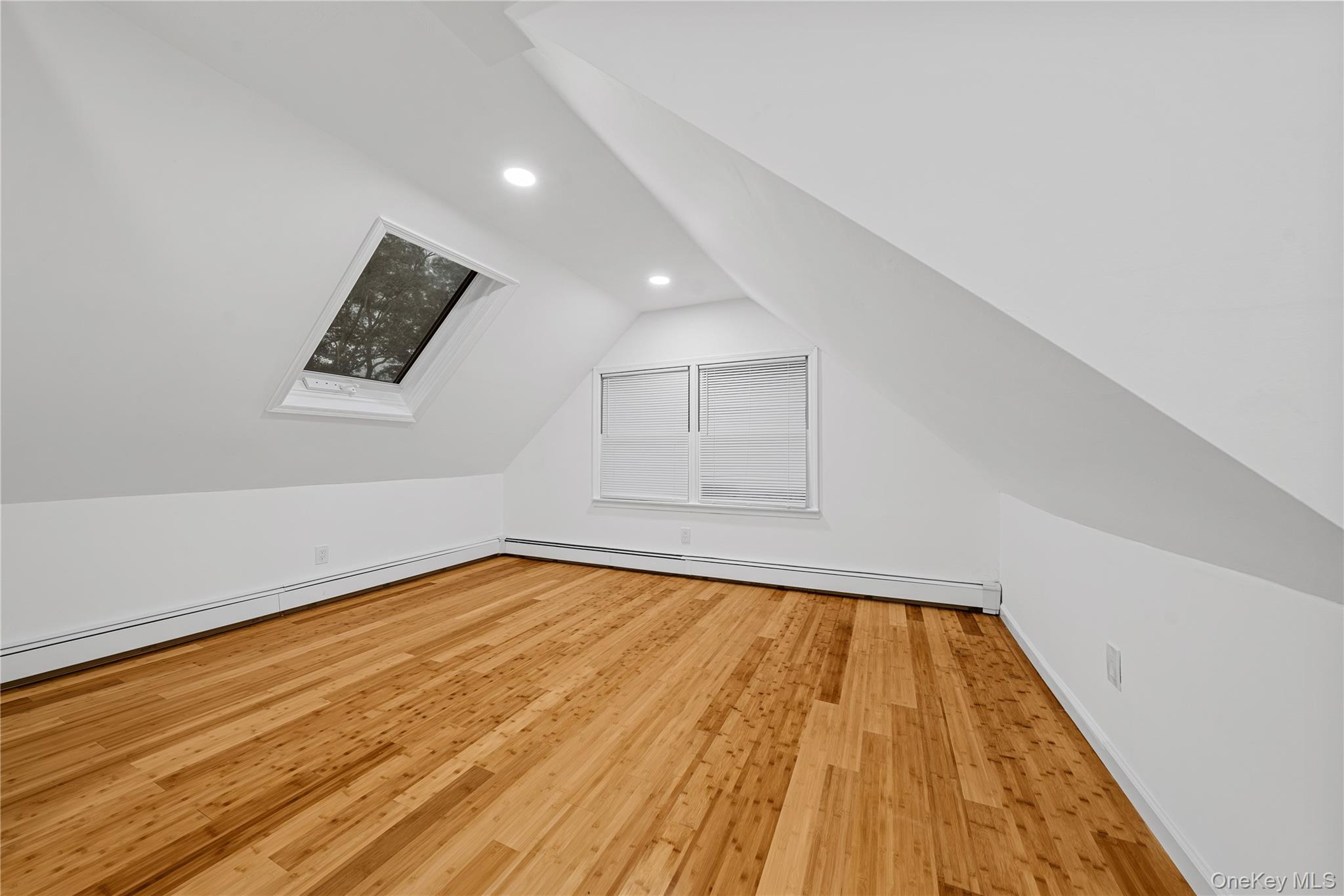 57 Eastwood Road Miller Place, NY 11764 - Photo 25 of 49 a view of an empty room with wooden floor and a window