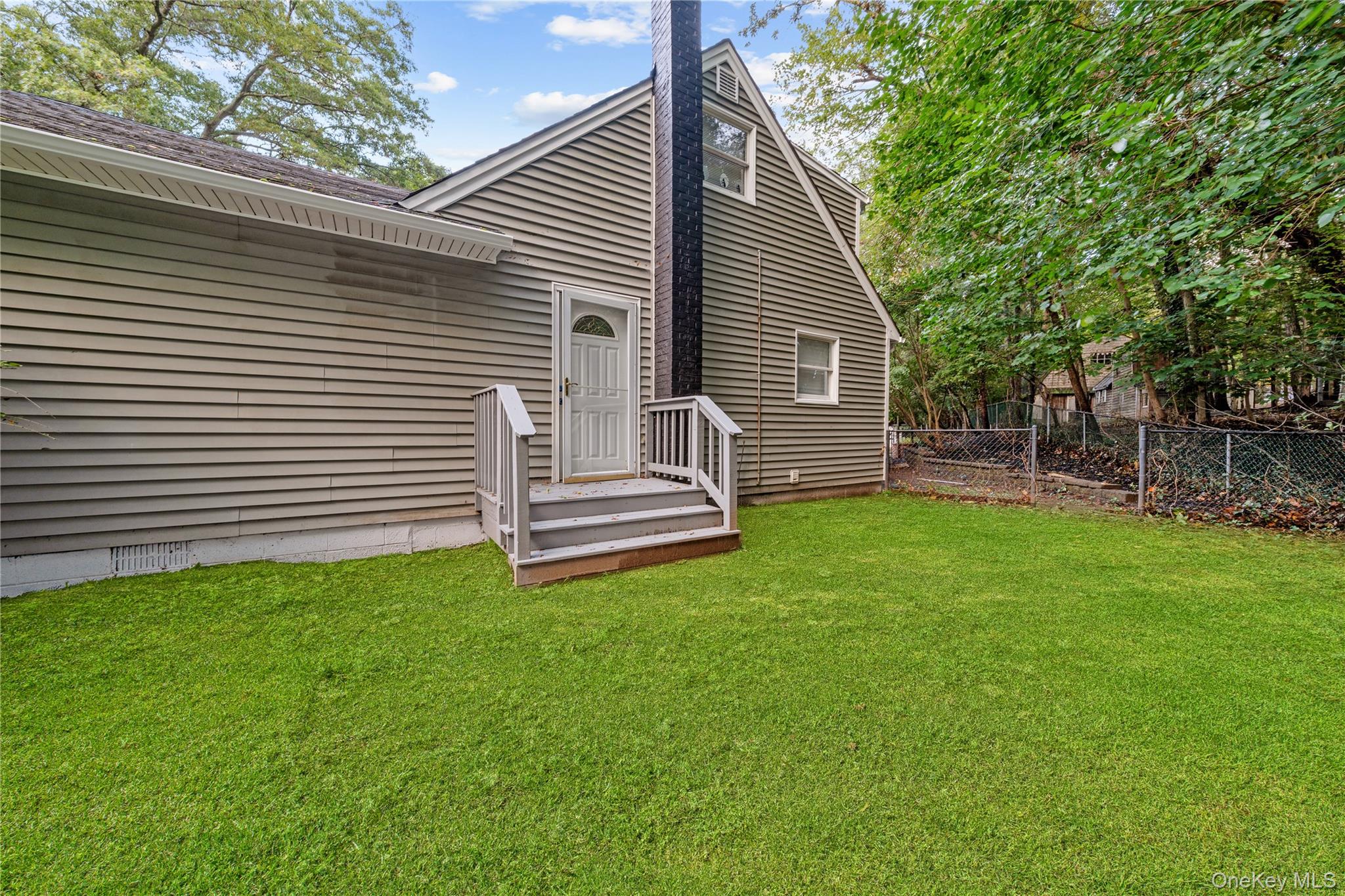 57 Eastwood Road Miller Place, NY 11764 - Photo 35 of 49 a view of a house with backyard and sitting area