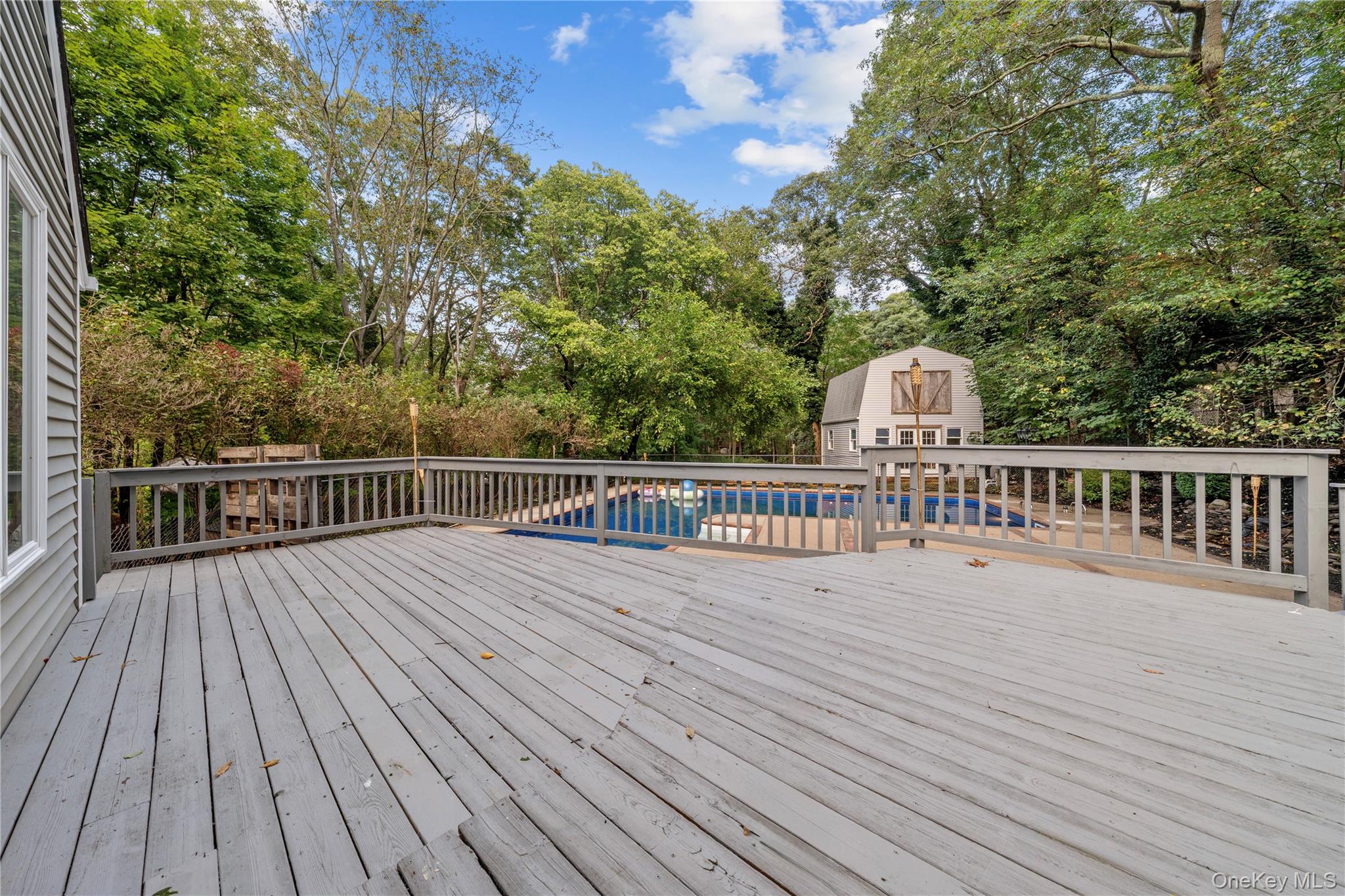 57 Eastwood Road Miller Place, NY 11764 - Photo 38 of 49 a view of balcony with wooden floor and fence