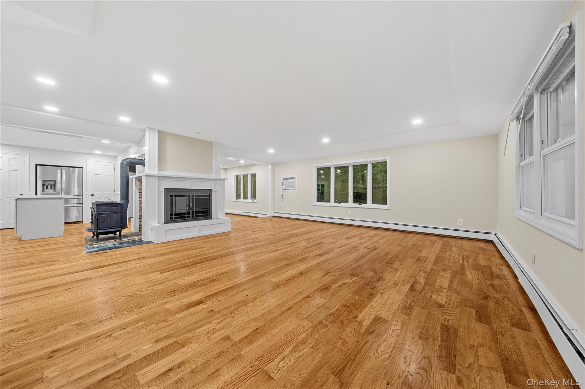 57 Eastwood Road Miller Place, NY 11764 - Photo 7 of 49 a view of empty room with wooden floor and fireplace