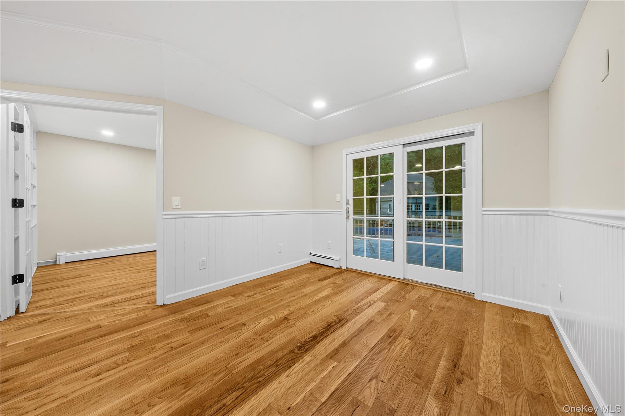 57 Eastwood Road Miller Place, NY 11764 - Photo 10 of 49 wooden floor in an empty room with a window
