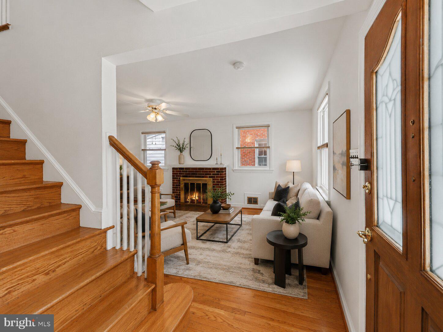 4504 20th Street Northeast Washington, DC 20018 - Photo 12 of 48 a living room with furniture a fireplace and a floor to ceiling window