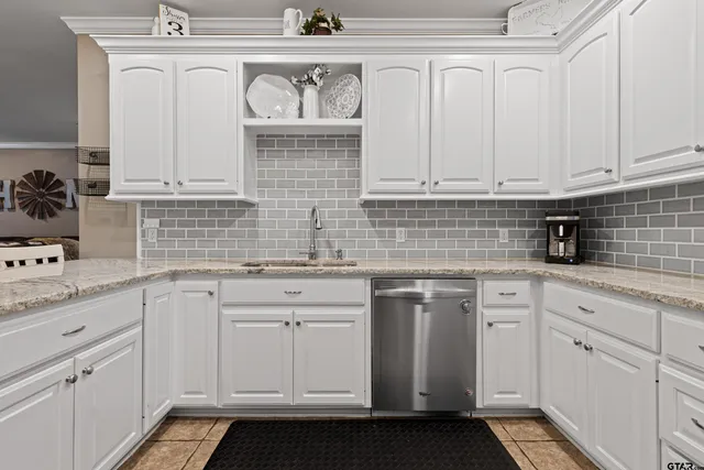 a kitchen with white cabinets and white appliances