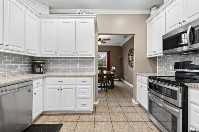 a kitchen with stainless steel appliances a stove sink and cabinets