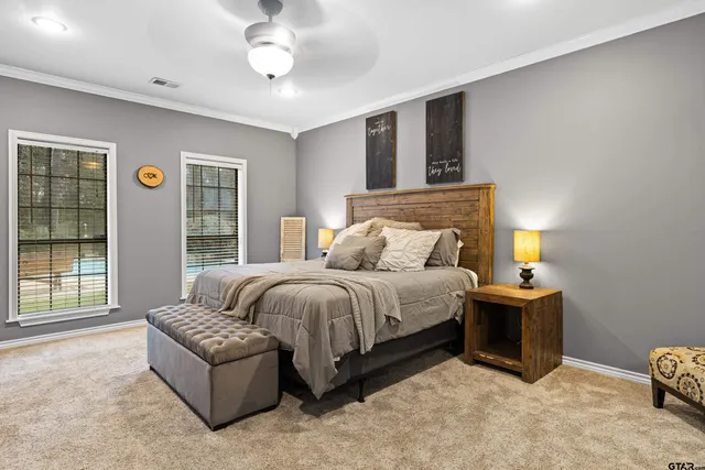 a bedroom with a bed and glass window