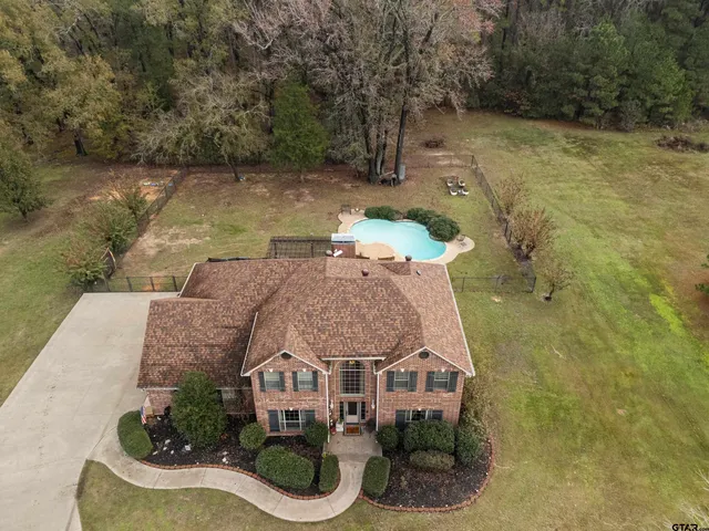 a aerial view of a house with swimming pool