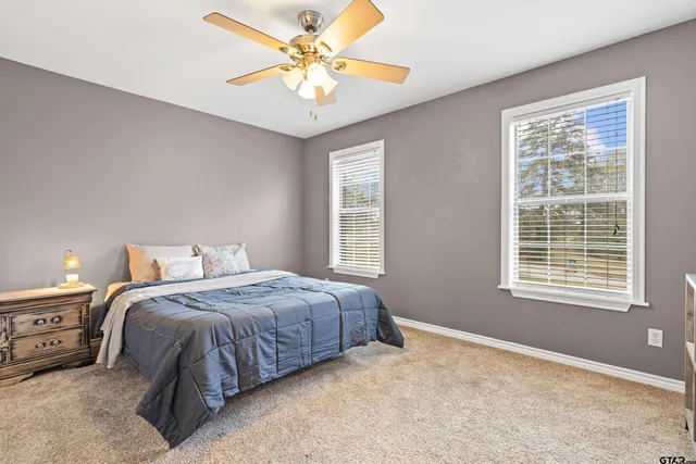 a spacious bedroom with a bed a chandelier and closet
