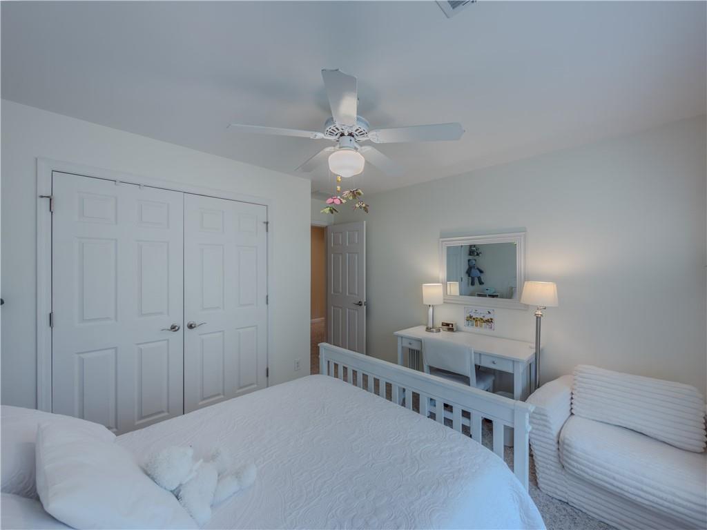 4284 Cedar Bluff Way Southwest Lilburn, GA 30047 - Photo 38 of 62 a bedroom with a bed and a chandelier