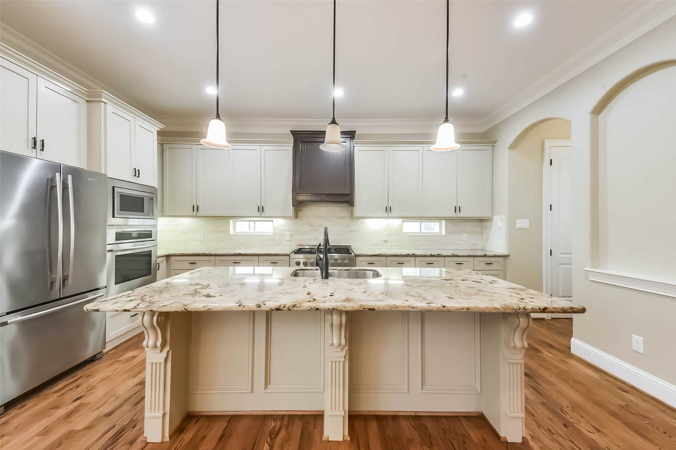 1126 West 16th Street, Unit C Houston, TX 77008 - Photo 17 of 44 a kitchen with kitchen island granite countertop a sink a counter space appliances and cabinets