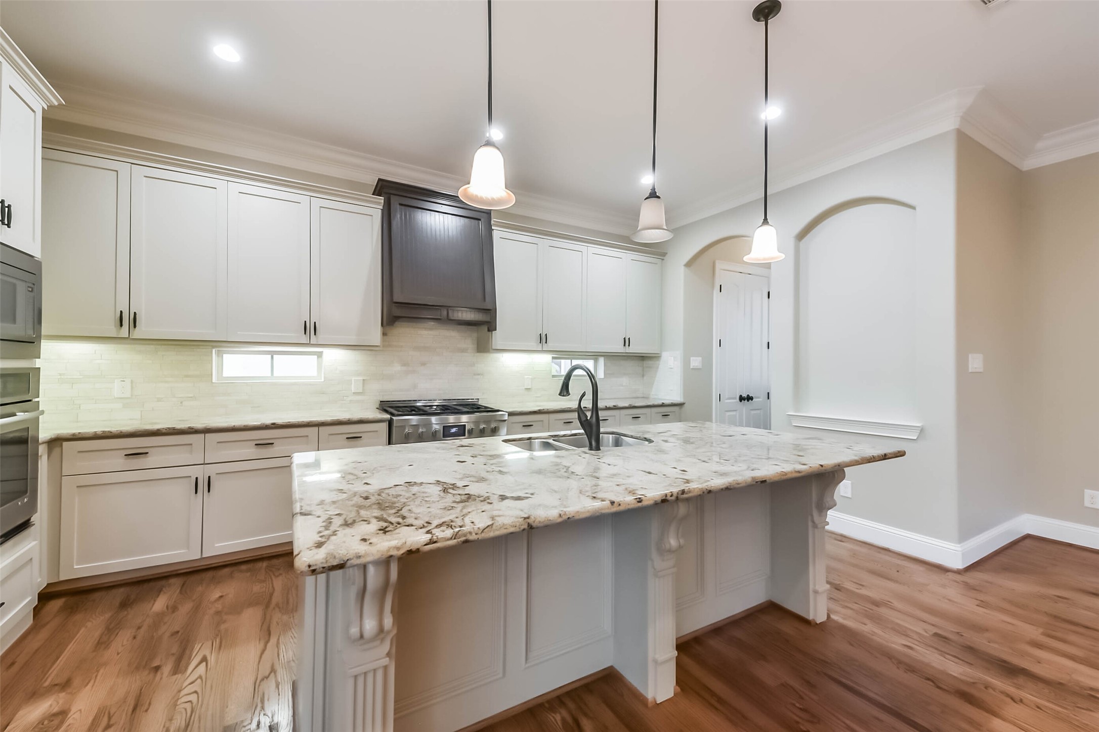 1126 West 16th Street, Unit C Houston, TX 77008 - Photo 18 of 44 a kitchen with kitchen island granite countertop a sink a counter space appliances and cabinets